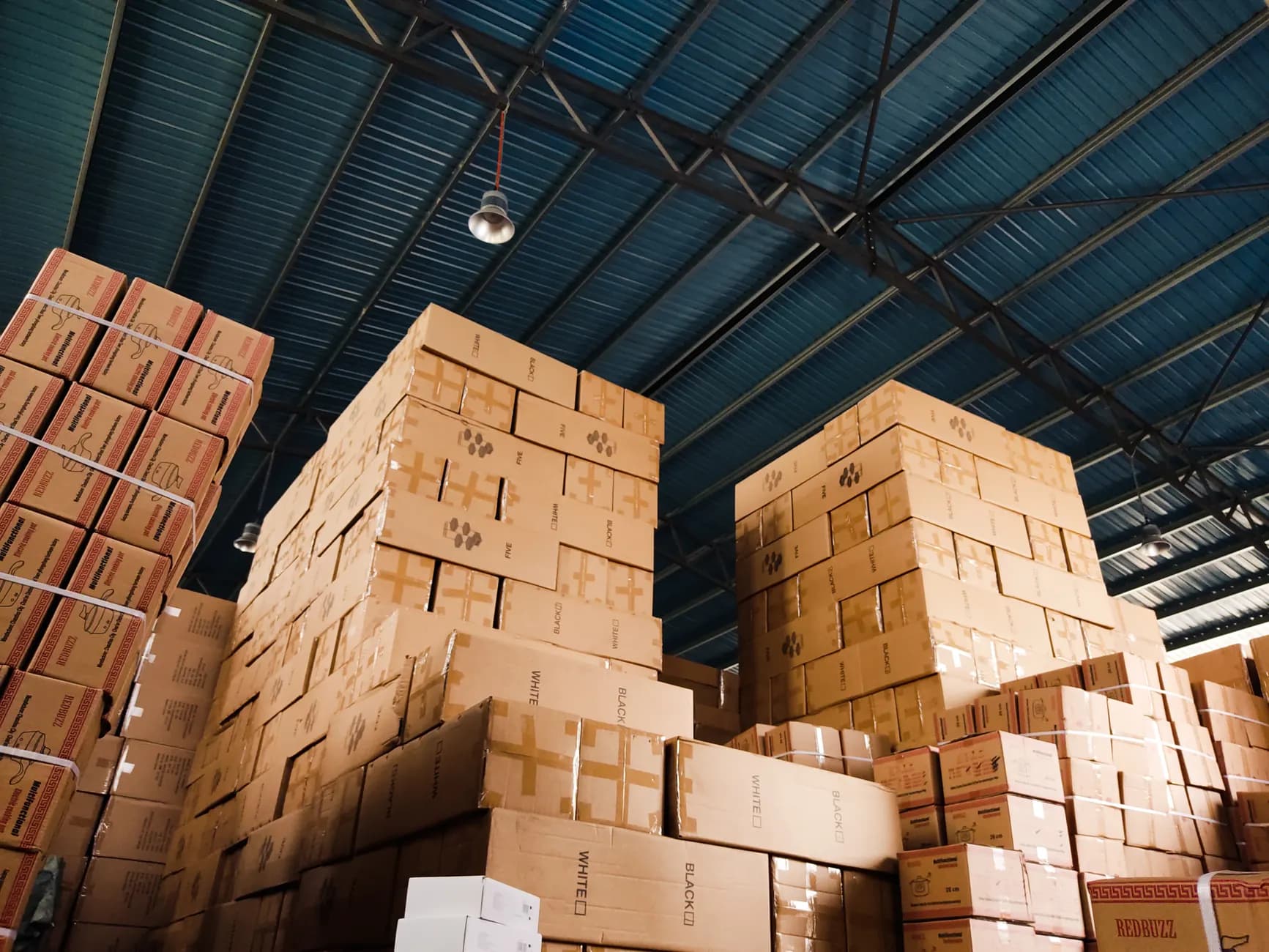 Stacked export cartons in a warehouse aisle